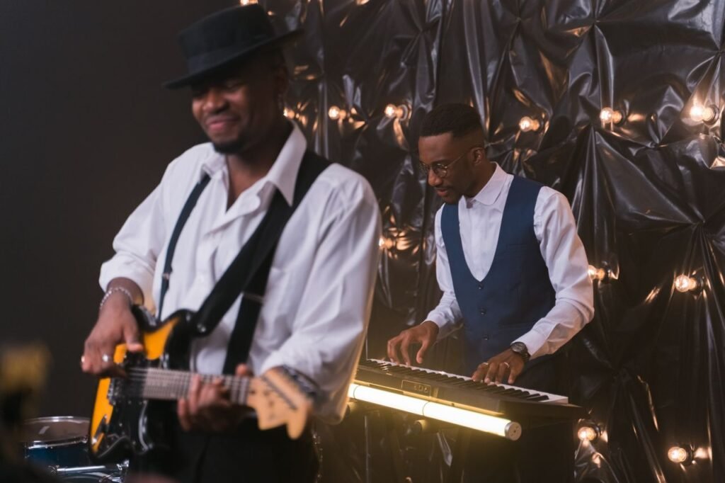 Dynamic live music performance featuring a guitarist and keyboardist in a stylish indoor setting.